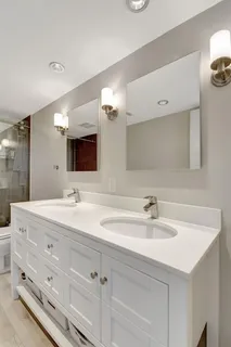 a bathroom with a double vanity sink and mirror