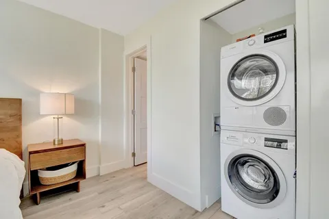 a view of a bedroom with washer and dryer