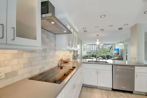 a kitchen with white cabinets and appliances