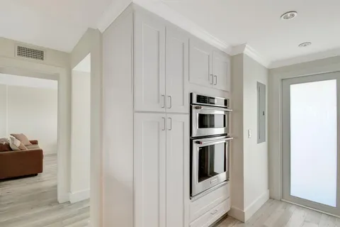 a kitchen with stainless steel appliances and white cabinets
