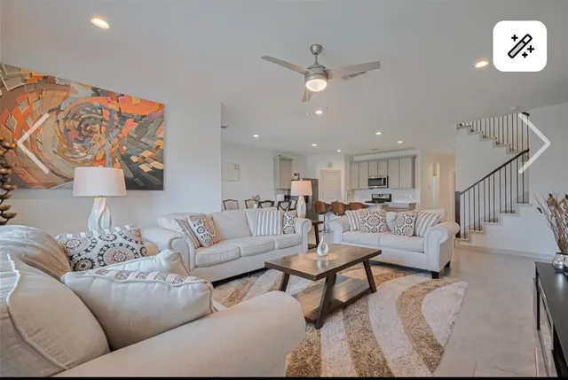 a living room with furniture and a ceiling fan