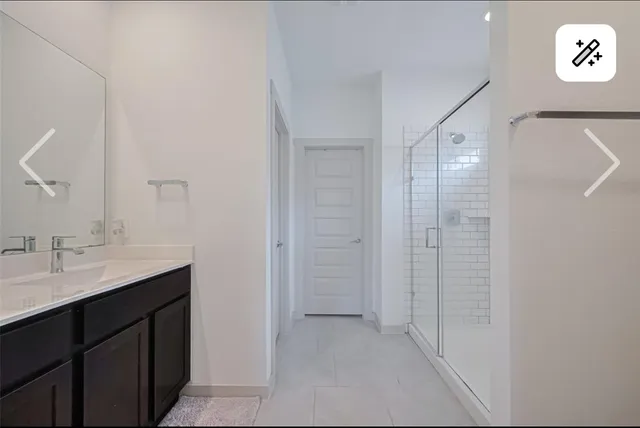a bathroom with a double vanity sink and mirror