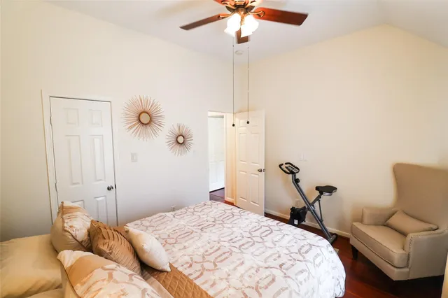 a bedroom with a bed and a flat tv screen on the dresser