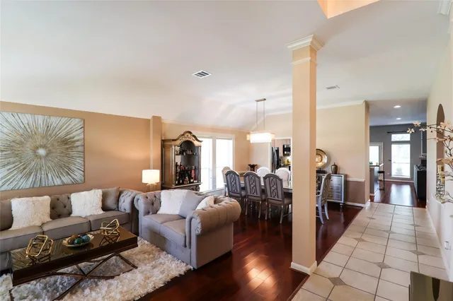 a living room with furniture and wooden floor