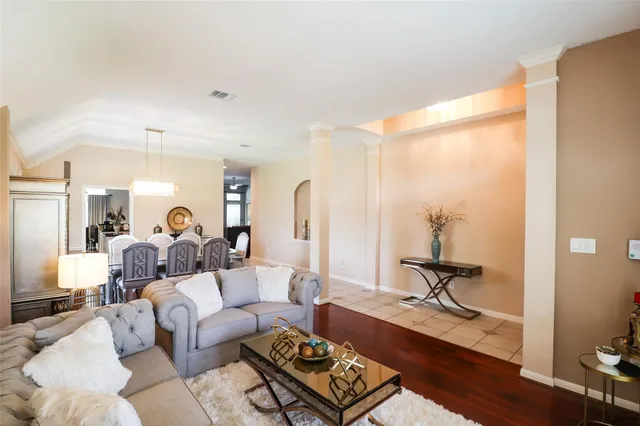 a living room with furniture and a mirror
