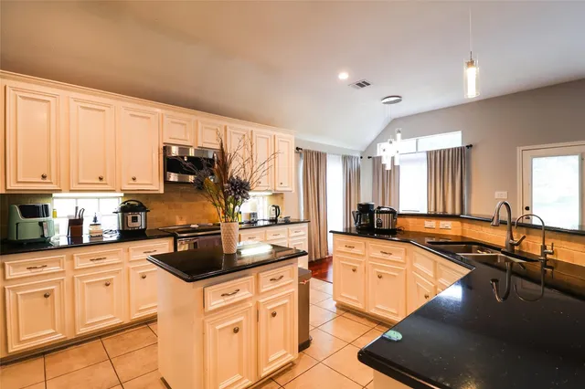 a kitchen with counter top space cabinets and stainless steel appliances
