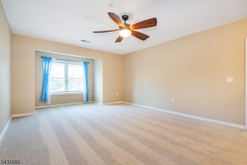16 Main Street Sparta, NJ 07871 - Photo 16 of 33 an empty room with ceiling fan and windows