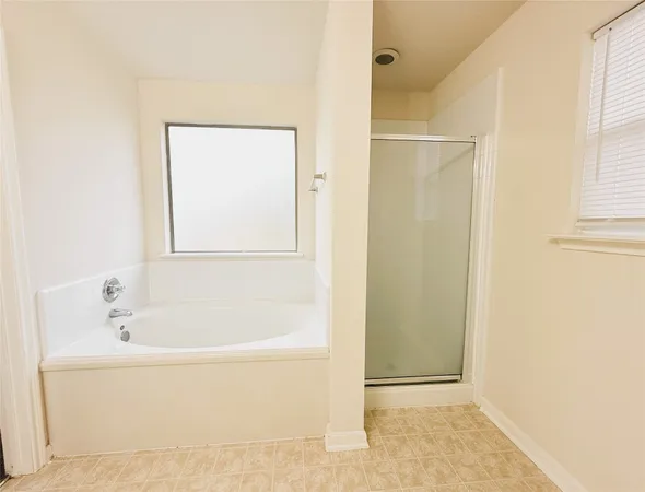 a white bath tub sitting next to a shower