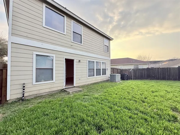 a view of a backyard with plants and a garden
