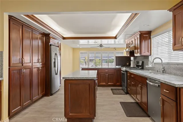 a kitchen with stainless steel appliances granite countertop a refrigerator and a sink