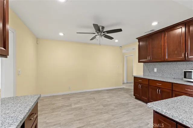 a kitchen with stainless steel appliances granite countertop a sink and a stove