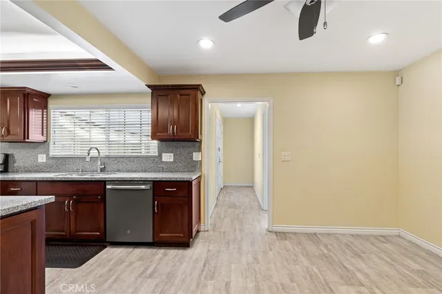 a kitchen with stainless steel appliances granite countertop a sink a stove a refrigerator and island