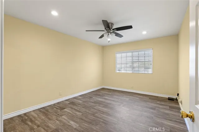a view of a big room with wooden floor closet and windows