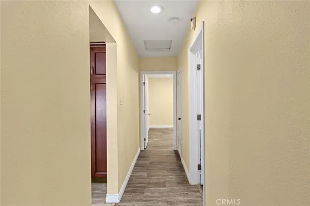 a view of a hallway with wooden floor