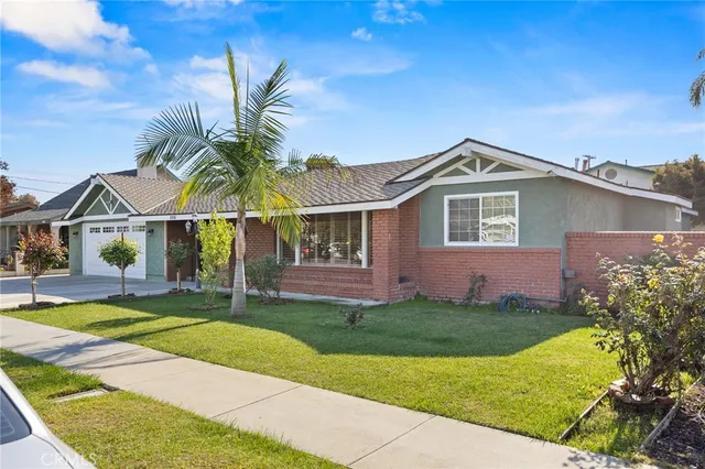 a front view of a house with a garden and yard