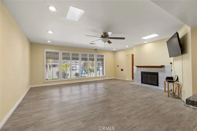 an empty room with windows fireplace and windows