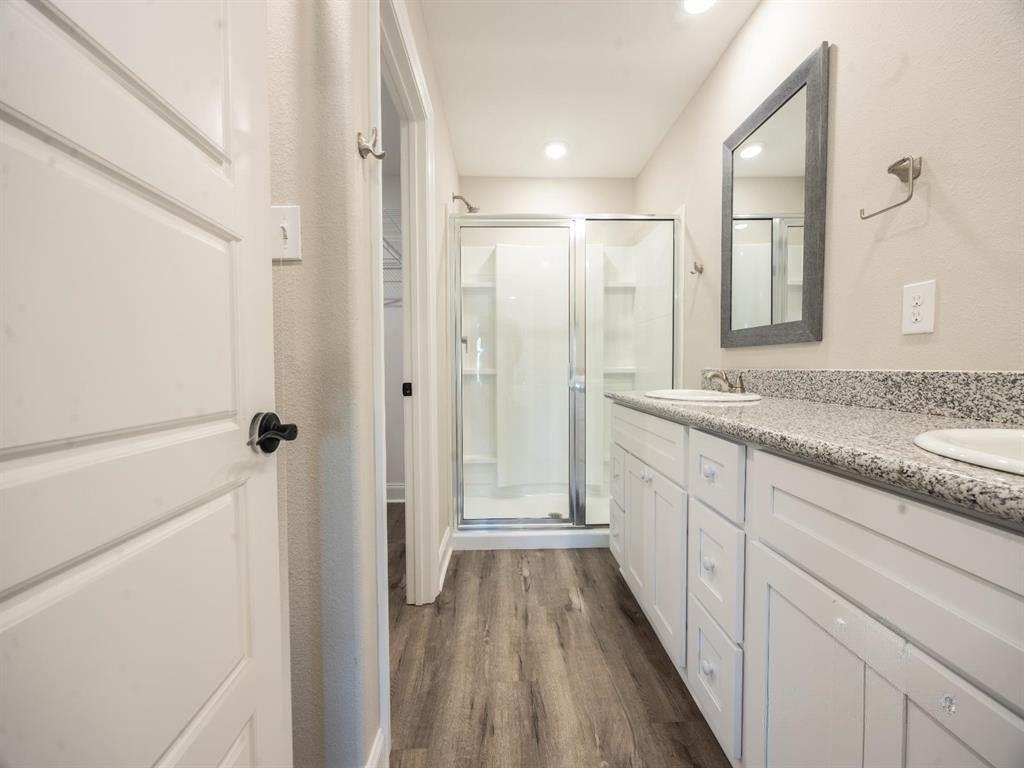 23906 Peppermint Street Elberta, AL 36530 - Photo 12 of 14 Bathroom with double vanity, a shower stall, dark wood finished floors, and recessed lighting