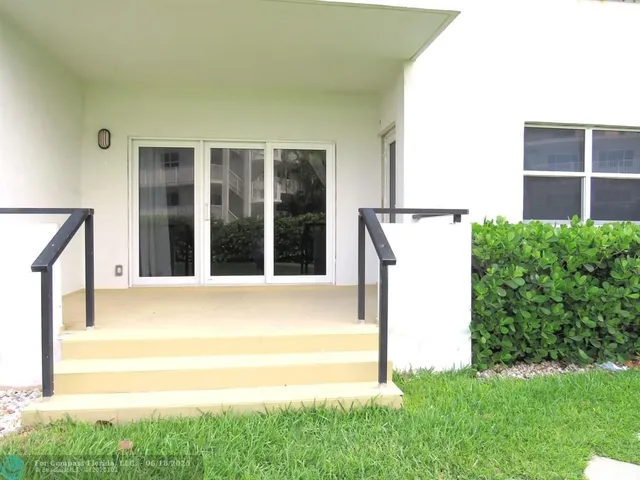 a view of backyard with a large window and a yard