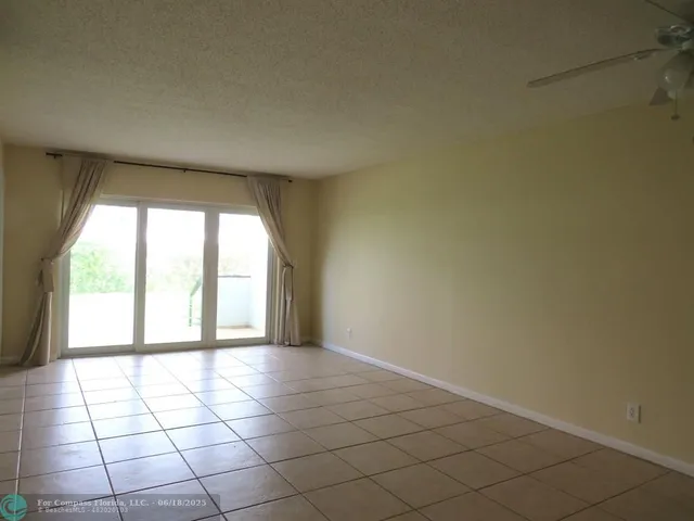 a view of an empty room and a window