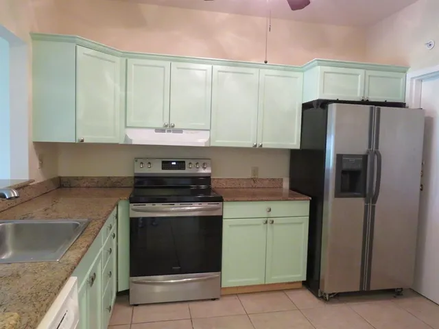 a kitchen with a stove a sink and a refrigerator