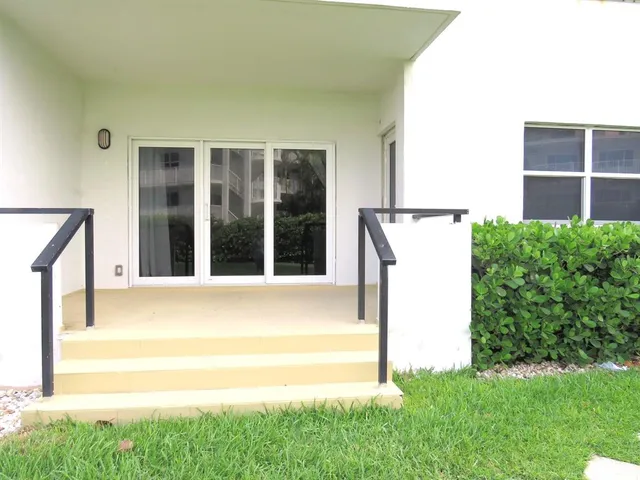 a view of backyard with a large window and a yard