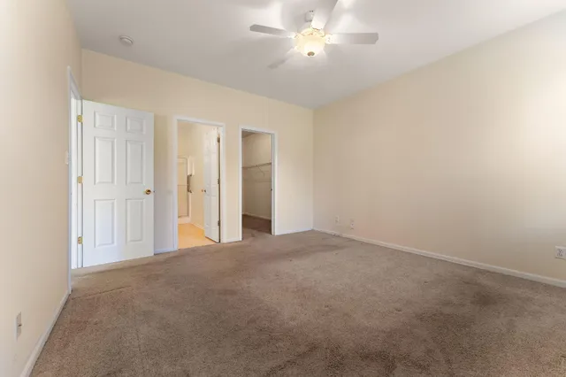 a view of an empty room with a ceiling fan