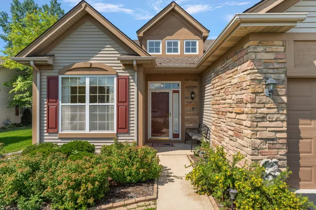 a front view of a house with a garden