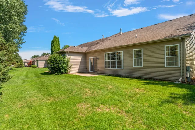 a view of a house with a backyard