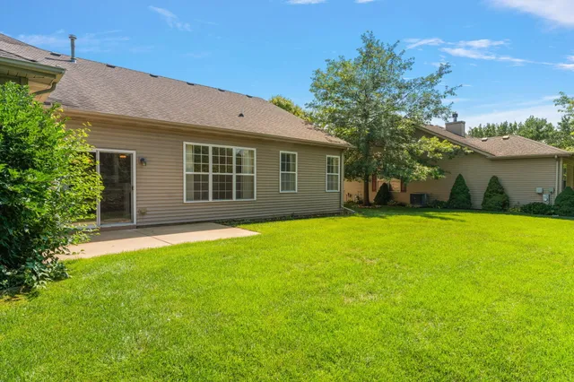 a front view of a house with a garden and yard