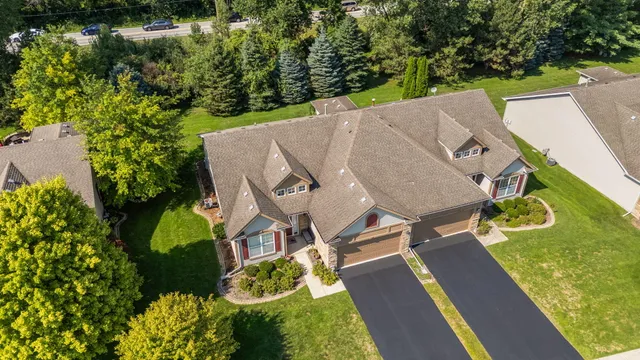 an aerial view of a house with swimming pool and garden
