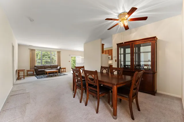 a view of a dining room with furniture and a large window