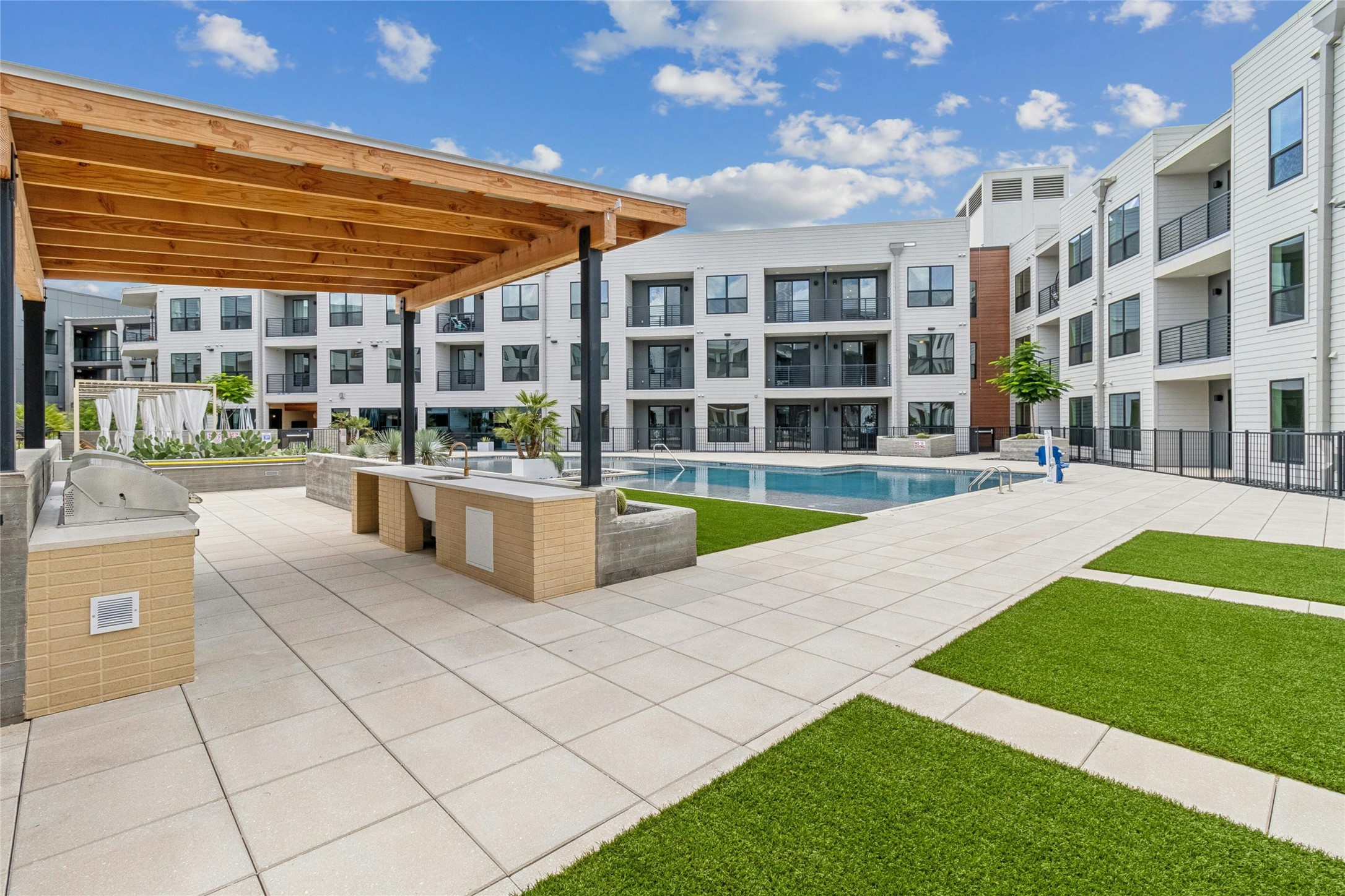 1701 Simond Avenue, Unit 401 Austin, TX 78723 - Photo 13 of 19 The pool and outdoor kitchen amenity area