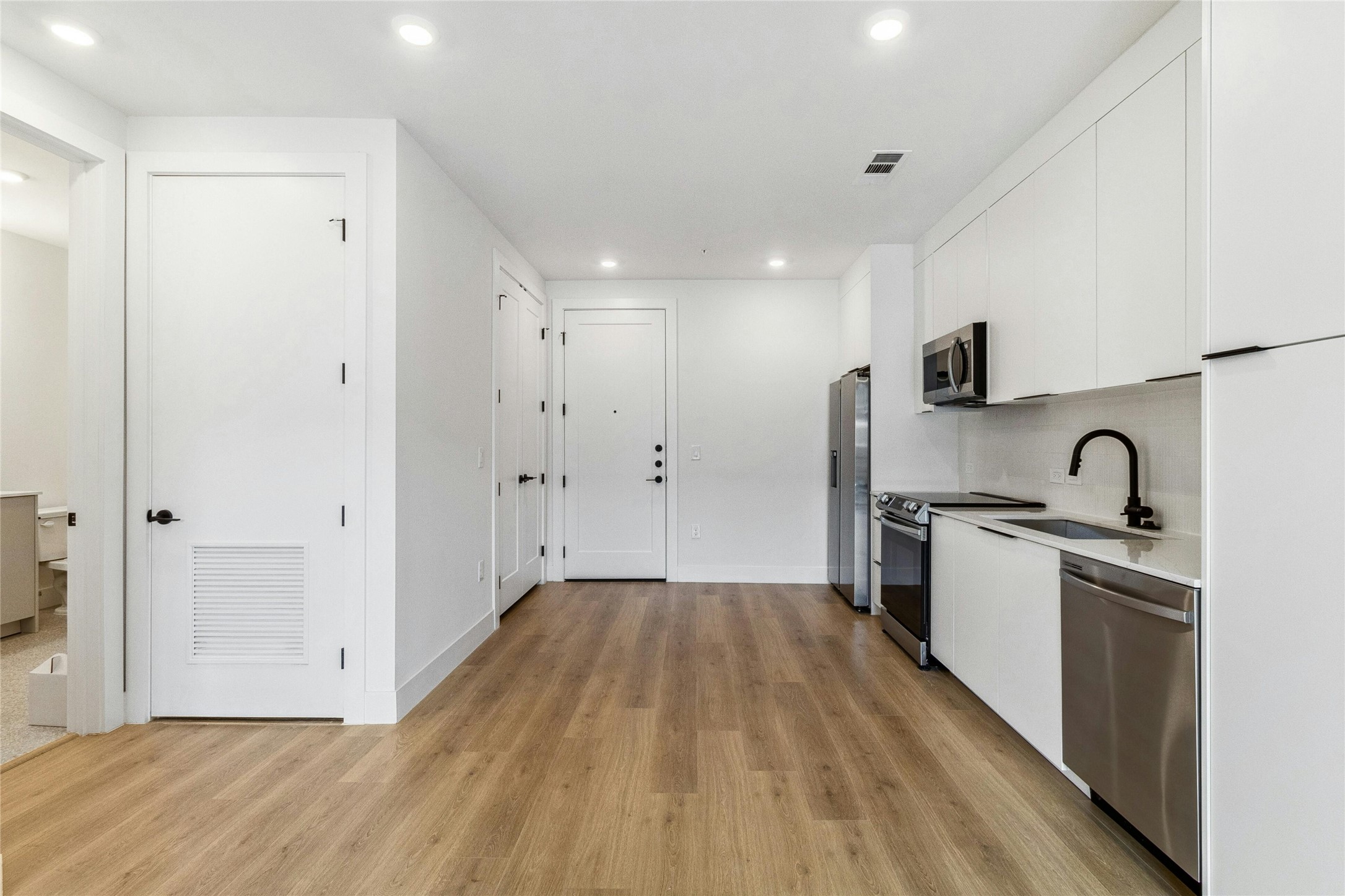 1701 Simond Avenue, Unit 401 Austin, TX 78723 - Photo 18 of 19 Front door to the unit enters into the open floor plan