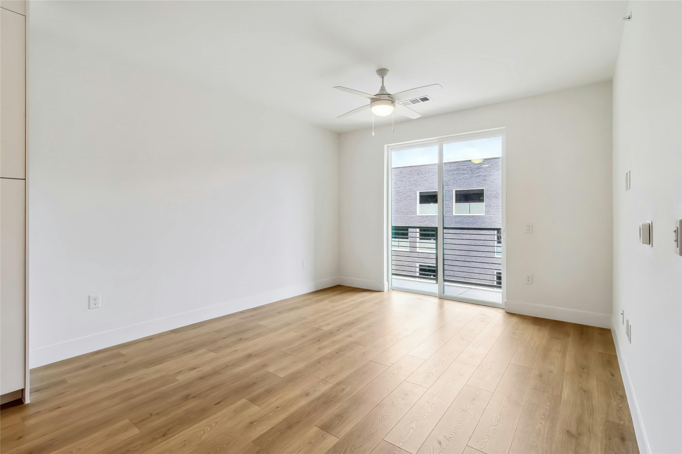 1701 Simond Avenue, Unit 401 Austin, TX 78723 - Photo 5 of 19 Living room with a ceiling fan and doors to the balcony