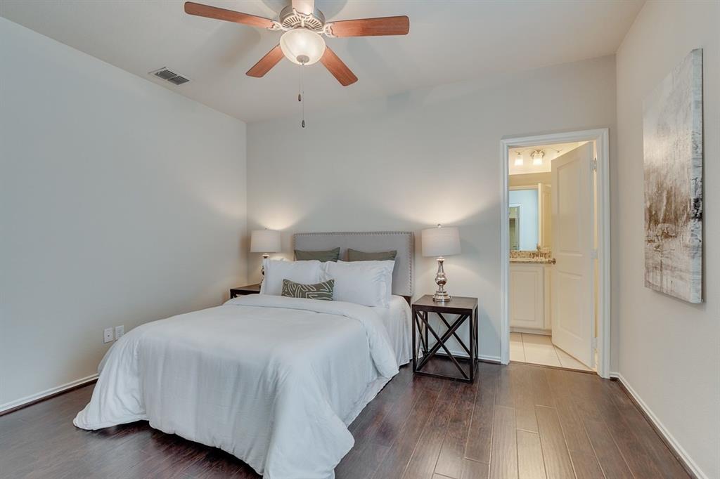 2701 McCart Avenue, Unit 101 Fort Worth, TX 76110 - Photo 17 of 21 a bedroom with a bed and a chandelier
