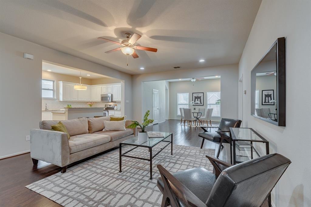 2701 McCart Avenue, Unit 101 Fort Worth, TX 76110 - Photo 8 of 21 a living room with furniture and a chandelier