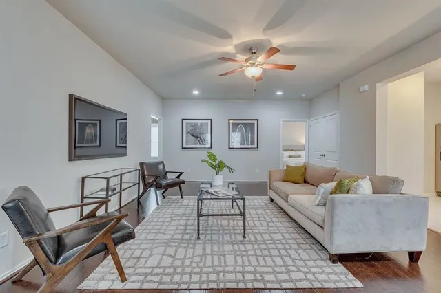 a living room with furniture and a ceiling fan