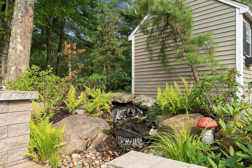 46 Jordan Road Holden, MA 01520 - Photo 36 of 42 a backyard of a house with a garden and outdoor seating