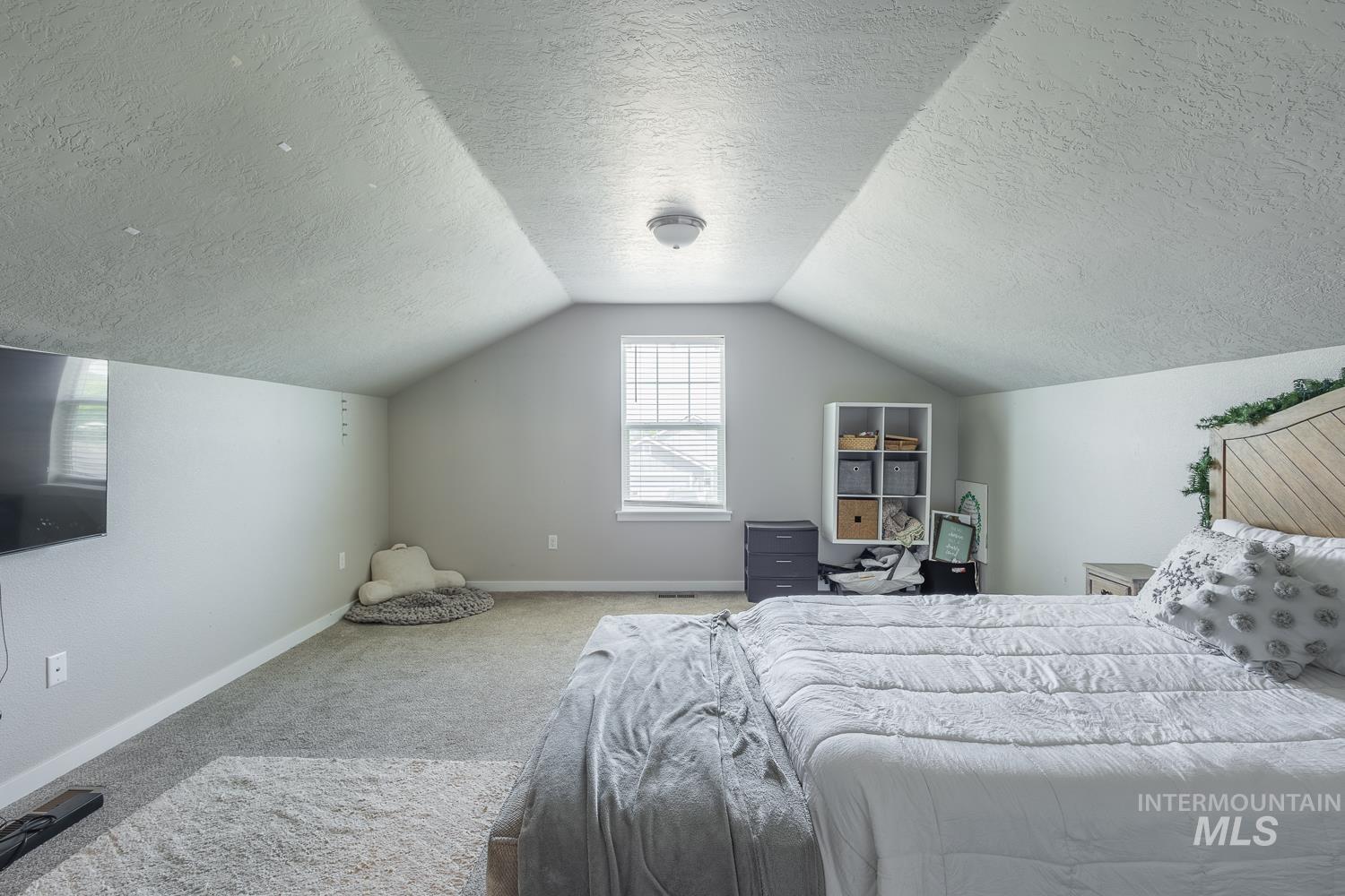 12623 Shadow Peak Street Caldwell, ID 83607 - Photo 43 of 50 Carpeted room featuring a sloped ceiling design and a single window with blinds