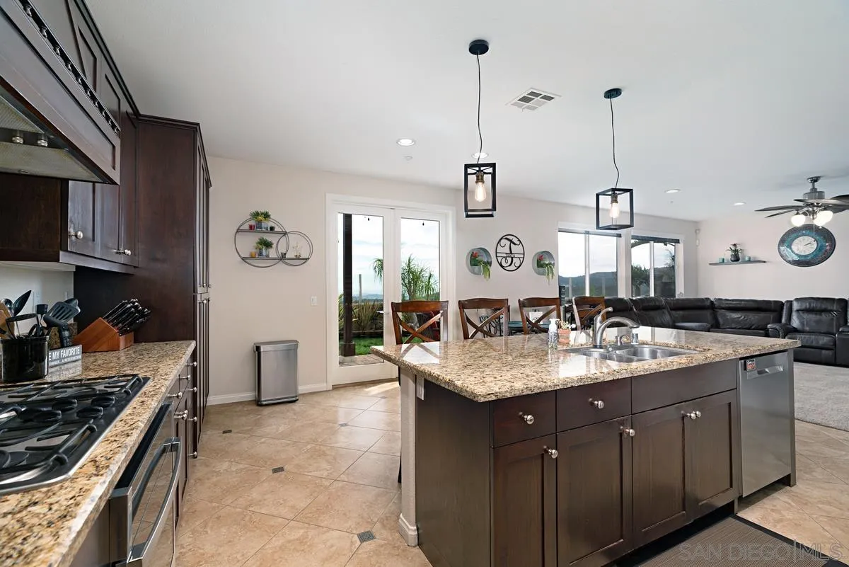 10689 Laurel Path Escondido, CA 92026 - Photo 16 of 48 a kitchen with a sink a stove and chairs