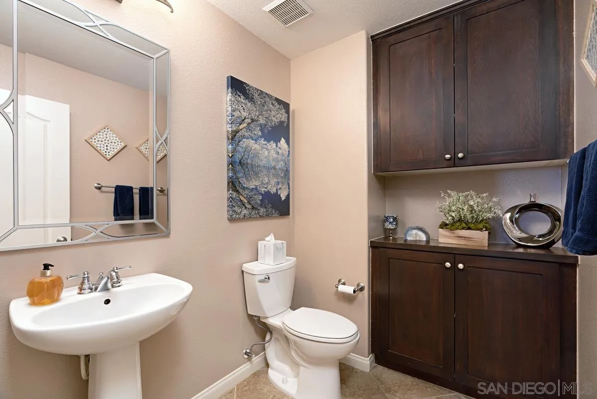 10689 Laurel Path Escondido, CA 92026 - Photo 19 of 48 a bathroom with a sink a toilet and mirror