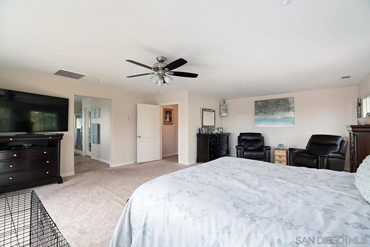 10689 Laurel Path Escondido, CA 92026 - Photo 21 of 48 a bedroom with a bed and a flat screen tv