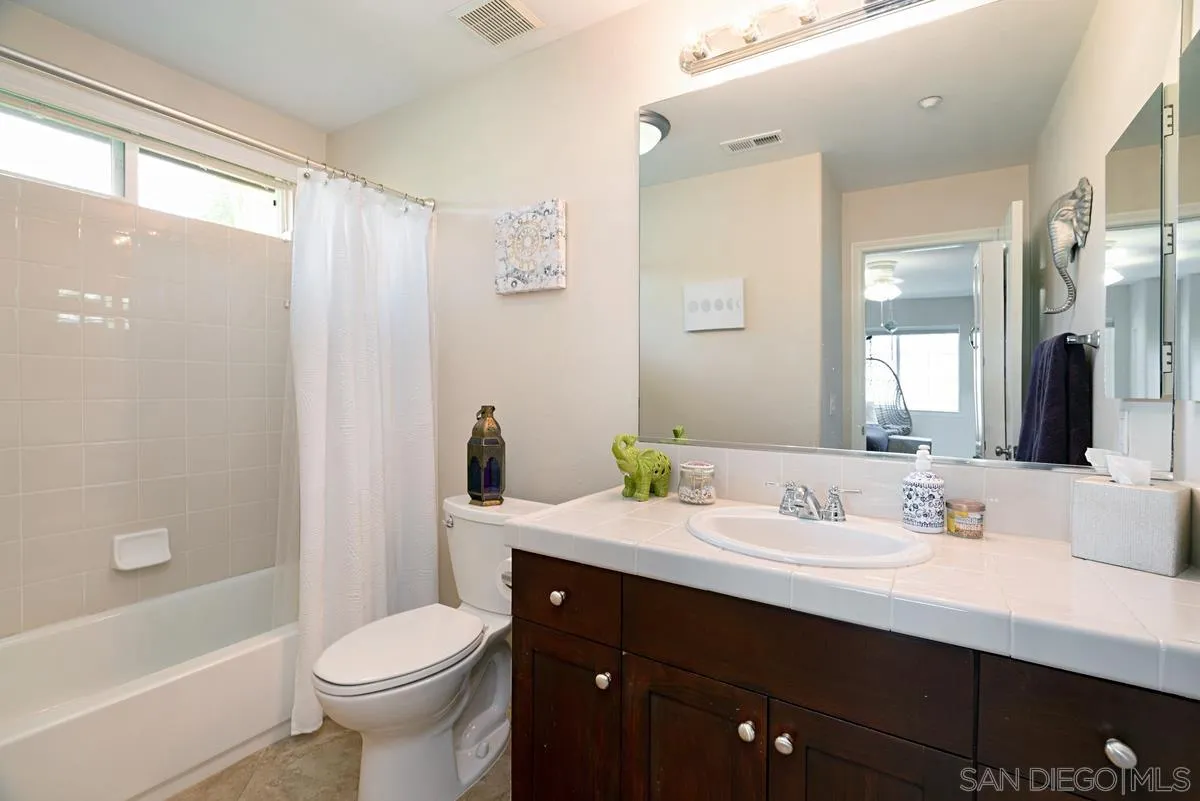 10689 Laurel Path Escondido, CA 92026 - Photo 27 of 48 a bathroom with a double vanity sink toilet and shower