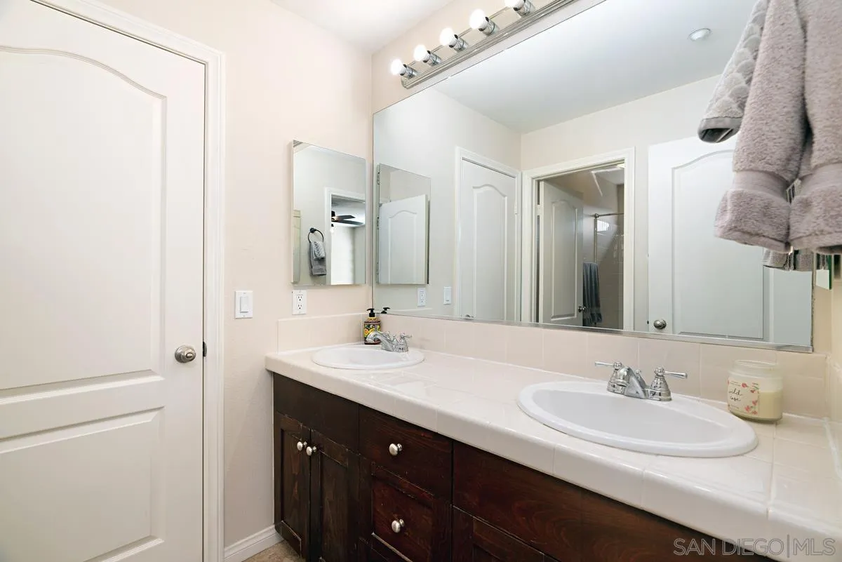 10689 Laurel Path Escondido, CA 92026 - Photo 30 of 48 a bathroom with a sink a vanity and a mirror