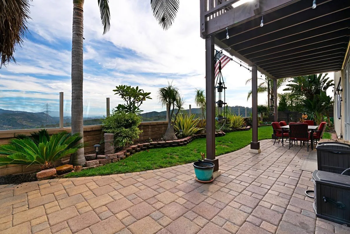 10689 Laurel Path Escondido, CA 92026 - Photo 31 of 48 a view of a patio with table and chairs potted plants with wooden fence