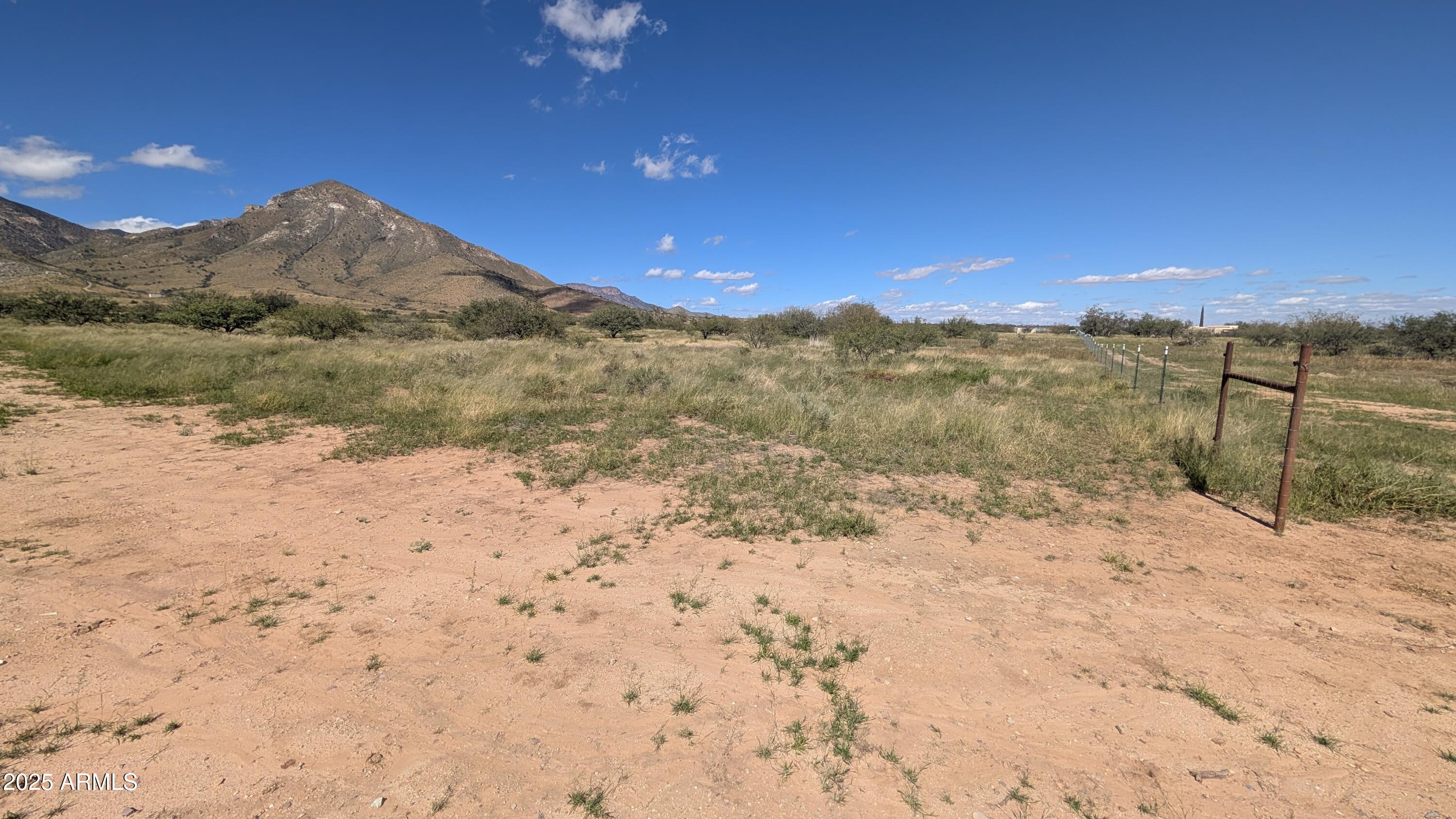 Tbd South Coronado Memorial Road, Unit 50 Hereford, AZ 85615 - Photo 14 of 27 a view of a dry yard with wooden fence and mountain view