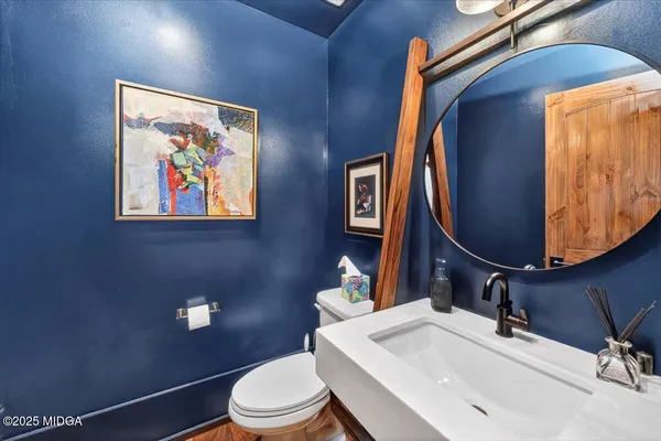a bathroom with a toilet and a mirror