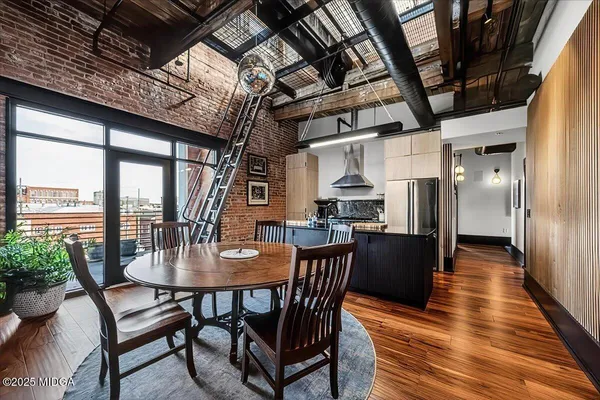 a dining room with furniture window and wooden floor
