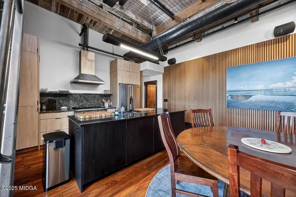 a kitchen with stainless steel appliances granite countertop a sink a stove and a refrigerator