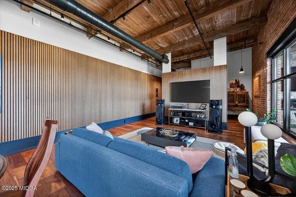 a living room with furniture and a flat screen tv